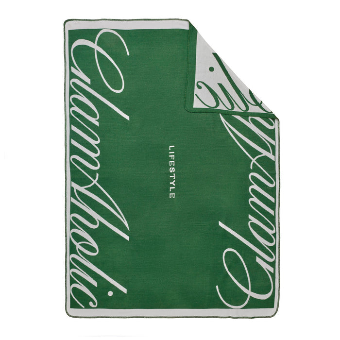 Green throw blanket featuring a bold white Glam-Aholic logo and lifestyle text, perfect for stylish home decor.