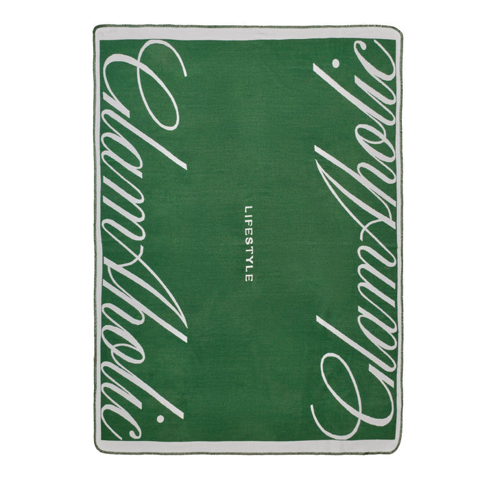 Green throw blanket featuring the Glam-Aholic logo and "LIFESTYLE" text, perfect for adding luxury to any space.