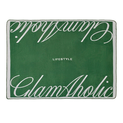 Luxurious green throw blanket featuring the Glam-Aholic logo and "LIFESTYLE" text for stylish home decor.