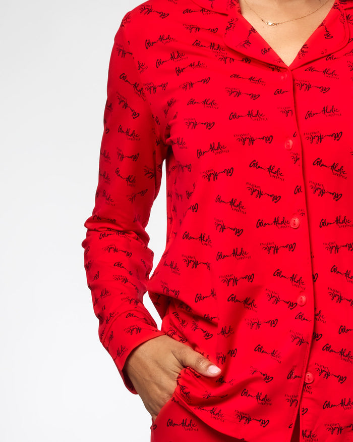 Red pajamas featuring a stylish signature print, designed for comfort and chic loungewear. Perfect for cozy nights.