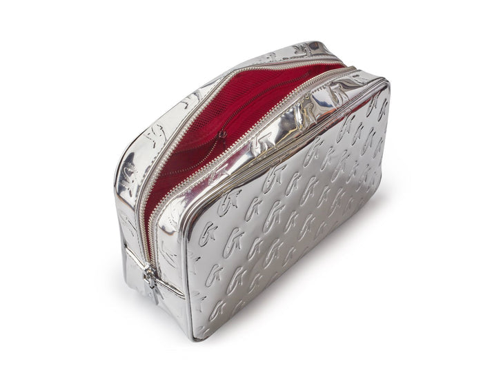 Small metallic silver monogram toiletry bag with embossed pattern and red interior, featuring dual zip closures.