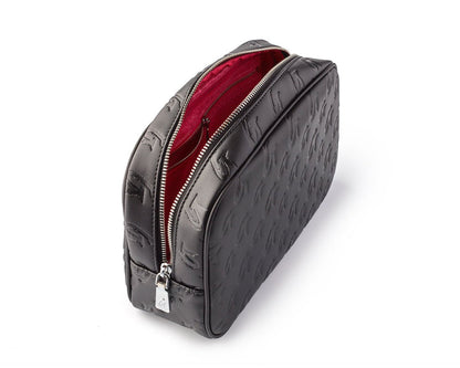 Small black and pink monogram toiletry bag with a zip closure and textured exterior, perfect for travel essentials.