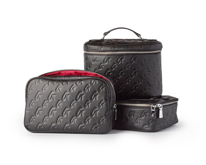 Small monogram toiletry bag set in black with pink interior, featuring stylish embossed design and zip closures.