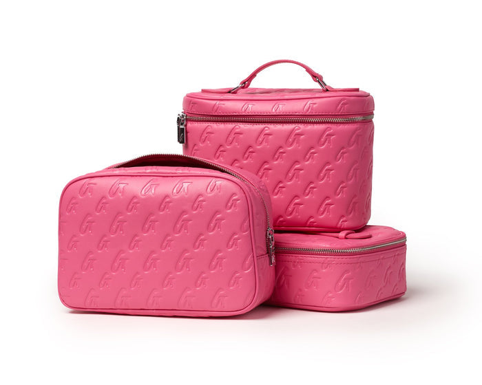 Set of three small hot pink monogram-embossed toiletry bags with silver zippers and a handle, perfect for travel organization.
