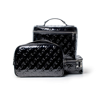 Black glossy monogram toiletry bag set with embossed G pattern, includes a small zippered pouch and larger travel cases.