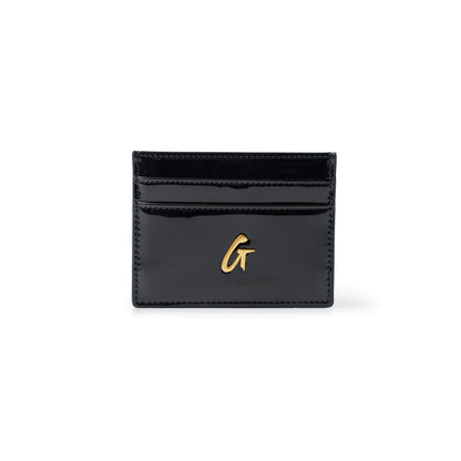 Black mirror finish card holder with gold "G" logo, featuring multiple card slots on a white background.