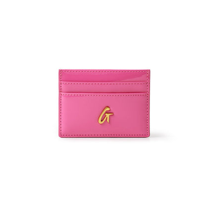 Mirror hot pink card holder with gold "G" logo and multiple card slots, compact and stylish for everyday use.