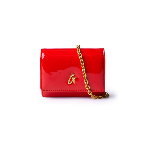 Compact wallet on chain in mirror red with a gold logo, perfect for adding a pop of color to any outfit.