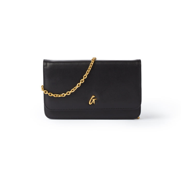 Black leather clutch with a gold chain strap and a gold "G" logo on the front, designed for stylish evening wear.