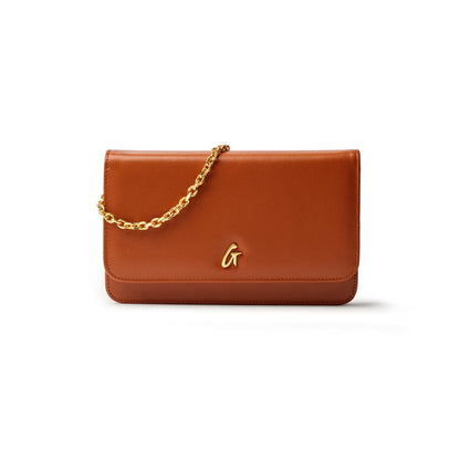 Brown leather handbag with a gold chain strap and a gold "G" logo on the front.