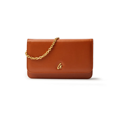 Brown leather handbag with a gold chain strap and a gold "G" logo on the front.