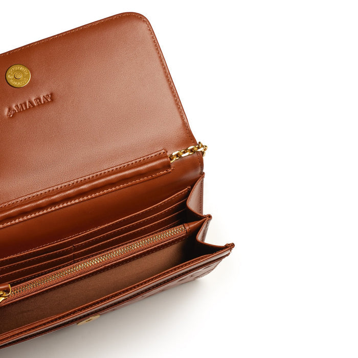 Open brown leather wallet with multiple card slots, zippered coin pocket, and gold chain detail, labeled "STANDARD GOLD WOC - BROWN.