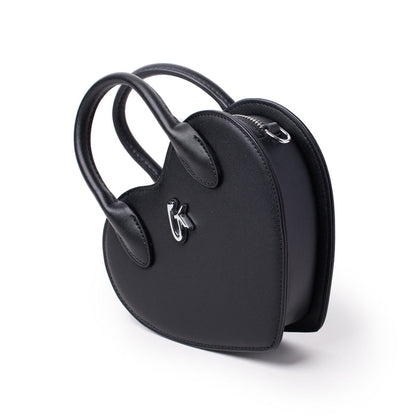 Black heart-shaped handbag with top handles, silver hardware, and a zipper closure, stylish and compact accessory.