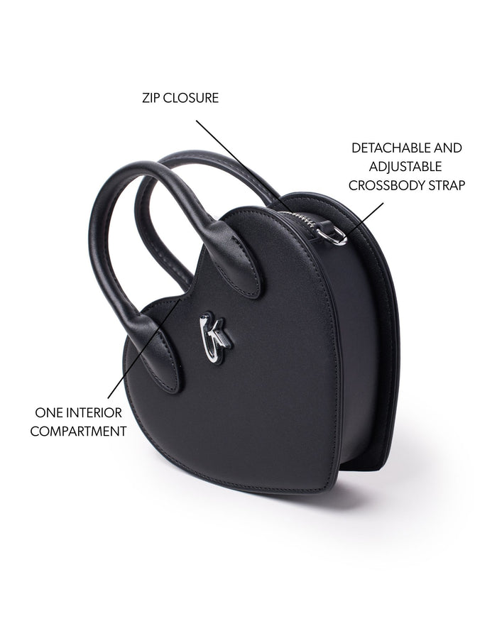 Black heart-shaped handbag featuring a zip closure, one interior compartment, and a detachable adjustable crossbody strap.