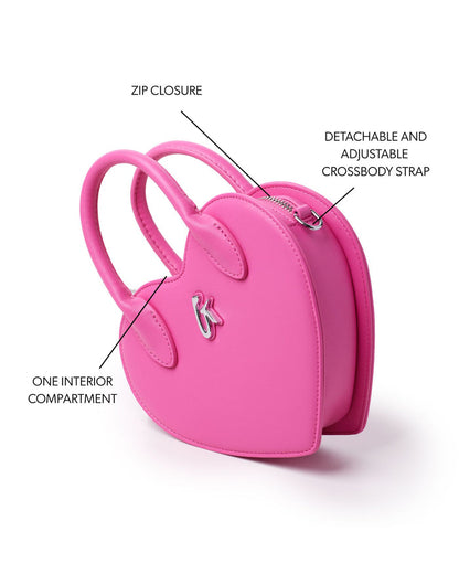 Pink heart-shaped handbag featuring a zip closure, one interior compartment, and a detachable adjustable crossbody strap.