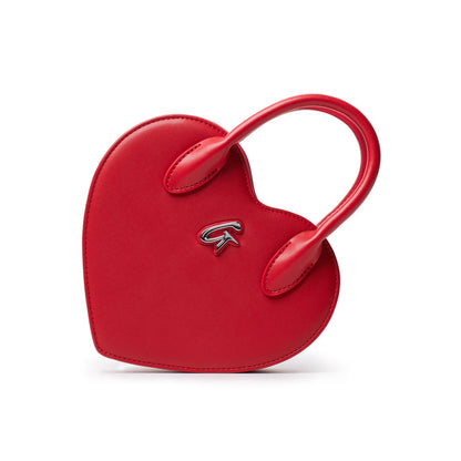 Red heart-shaped bag with a top handle and a small logo emblem on the front, designed for stylish everyday use.