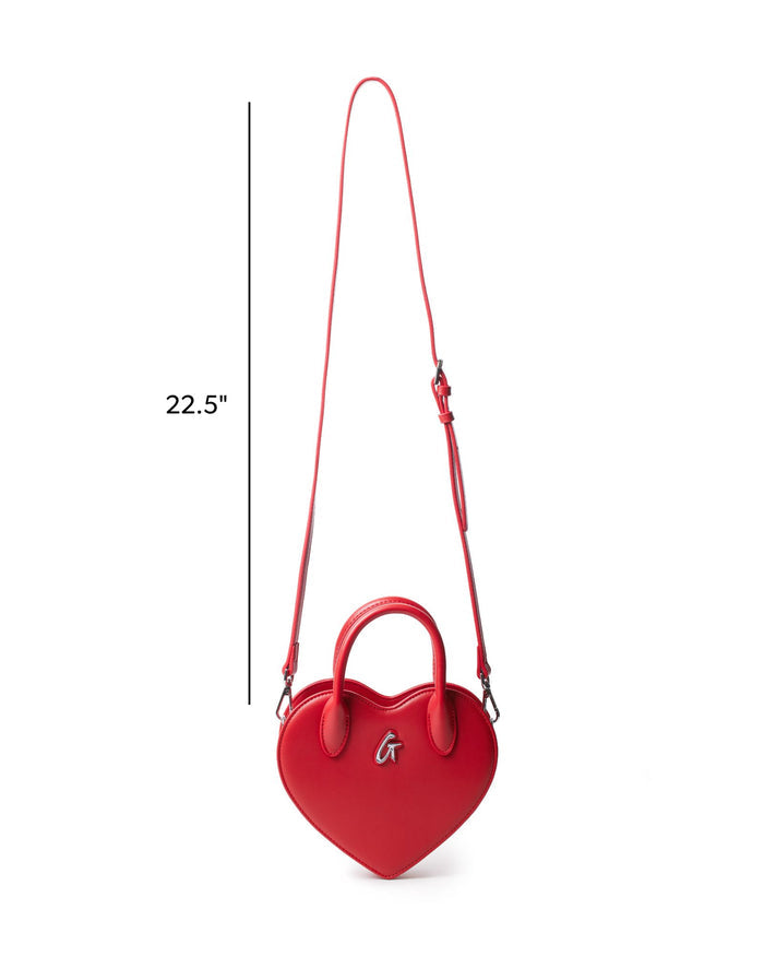 Red heart-shaped handbag with a top handle and adjustable shoulder strap, featuring a stylish logo detail.