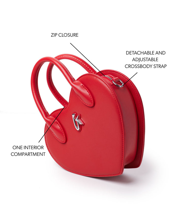 Red heart-shaped handbag featuring a zip closure, detachable adjustable crossbody strap, and one interior compartment.
