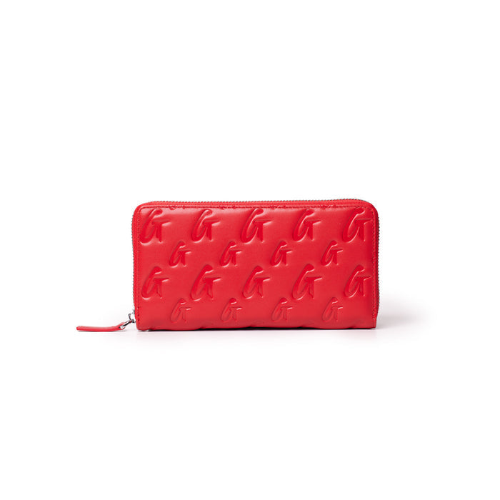 Red leather wallet with embossed G monogram pattern, zip-around closure, and sleek design.