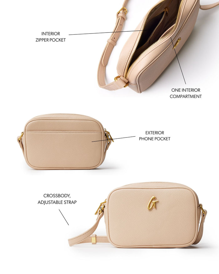 Nude pebble camera bag featuring an adjustable crossbody strap, exterior phone pocket, and interior zipper pocket.