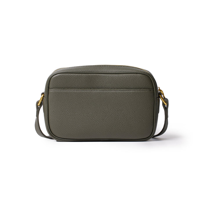 Olive green pebble leather camera bag with a front pocket, gold hardware, and adjustable strap for carrying.