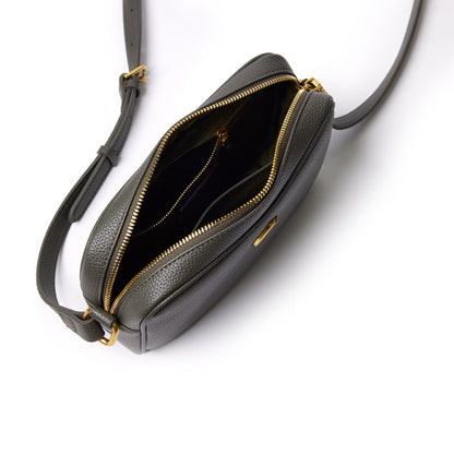 Olive green Pebble Camera Bag with gold zippers, open to show multiple compartments, adjustable strap, and compact design.