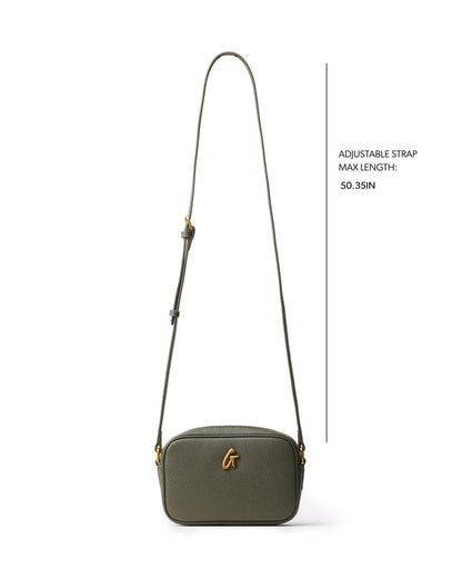 Olive green pebble camera bag with adjustable strap, featuring a sleek design and gold logo detail.