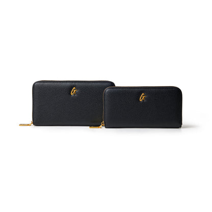 Black pebble leather wallets with gold zipper and "G" logo, one larger and one smaller, on a white background.