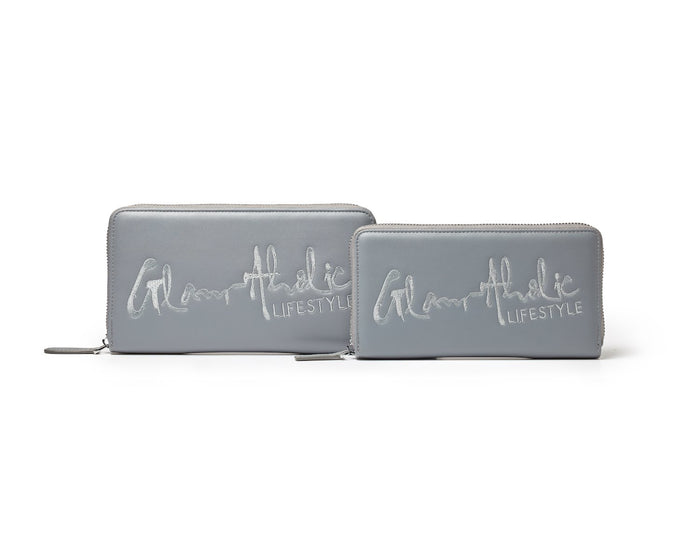 Gray signature logo wallets with "Glam Athletic Lifestyle" embroidered on the front, featuring silver zippers and sleek design.