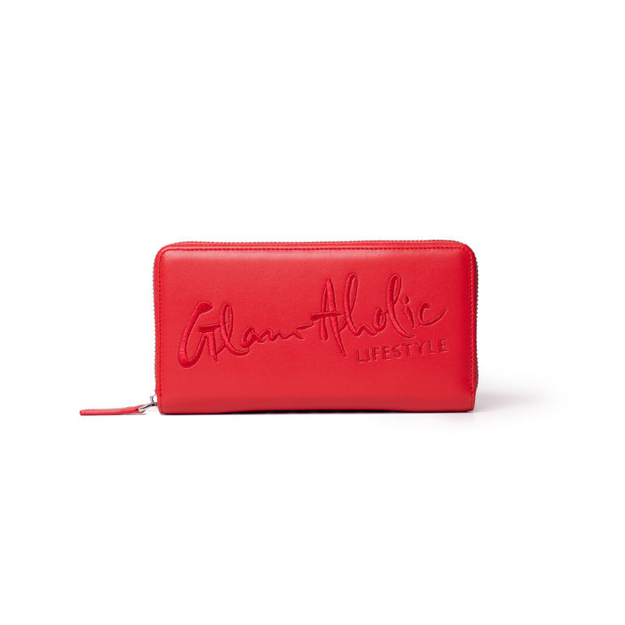 Red wallet with embossed "Glam-Aholic Lifestyle" logo, zip-around closure, stylish and spacious for essentials.