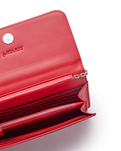 Red leather wallet with silver chain detail, multiple card slots, zippered compartment, and embossed "MIA RAY" logo.