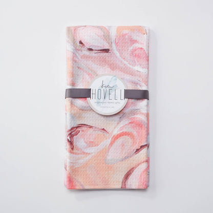 Towel with pink oyster pattern against white background