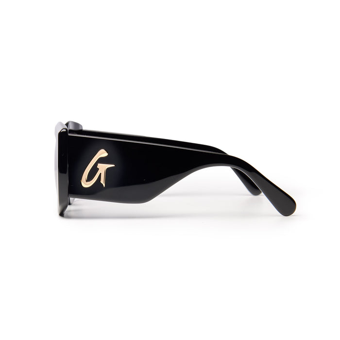 Stylish black sunglasses featuring a sleek design and a gold logo on the side, perfect for a chic look.