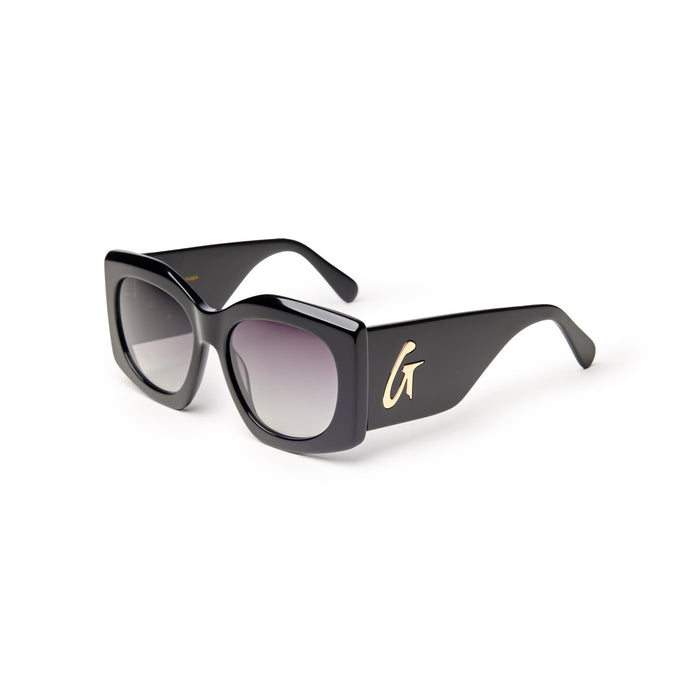 Oversized black sunglasses with gradient lenses and a gold logo on the side, offering a chic and stylish look.
