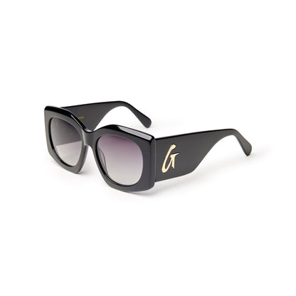 Oversized black sunglasses with gradient lenses and a gold logo on the side, offering a chic and stylish look.