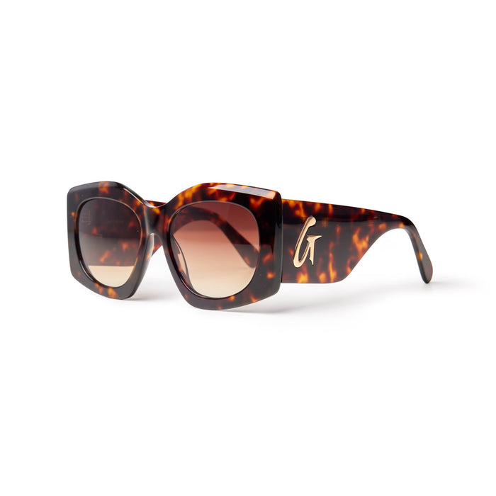 Oversized tortoise sunglasses with gradient lenses and a stylish logo on the arm, perfect for a chic look.