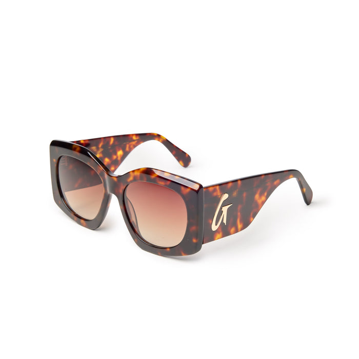 Oversized tortoise shell sunglasses featuring gradient lenses and a stylish logo on the side, perfect for a chic look.