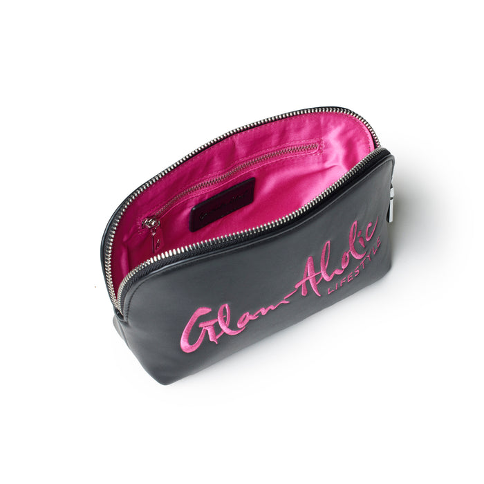 Black and pink cosmetic pouch featuring a zip closure and Glam-Aholic Lifestyle logo on the front. Ideal for organizing beauty essentials.