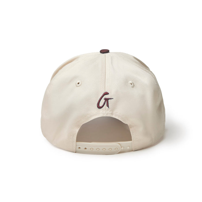 Burgundy trucker hat featuring a cream-colored back and adjustable snap closure for a comfortable fit.