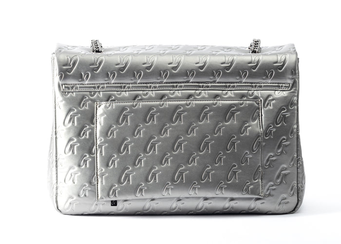 Silver XL Monogram Flap Bag with embossed G logo pattern, chain strap, and front pocket, in a sleek platinum finish.