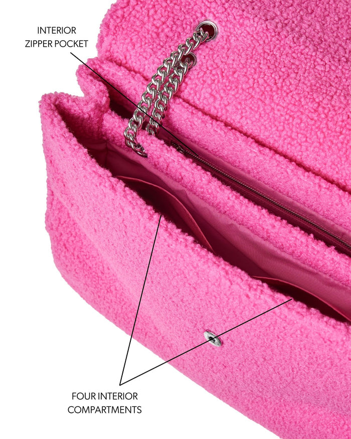 Hot pink XL Teddy flap bag featuring a plush exterior, interior zipper pocket, and four spacious compartments.