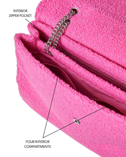 Hot pink XL Teddy flap bag featuring a plush exterior, interior zipper pocket, and four spacious compartments.